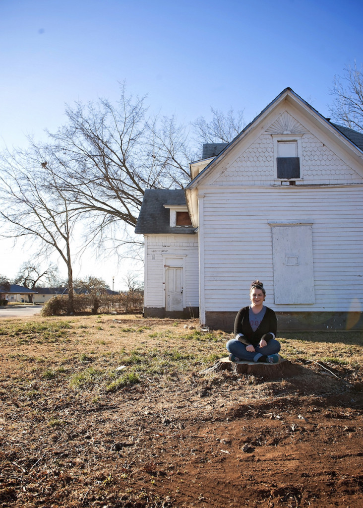 Our photographer, Rachel J Apple, sitting outside an old home in Stillwater, OK.